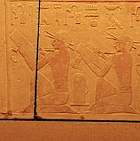 Detail from wall of tomb of Prince Kaninisut showing scribes in seated position. Please click on image to view larger image.
